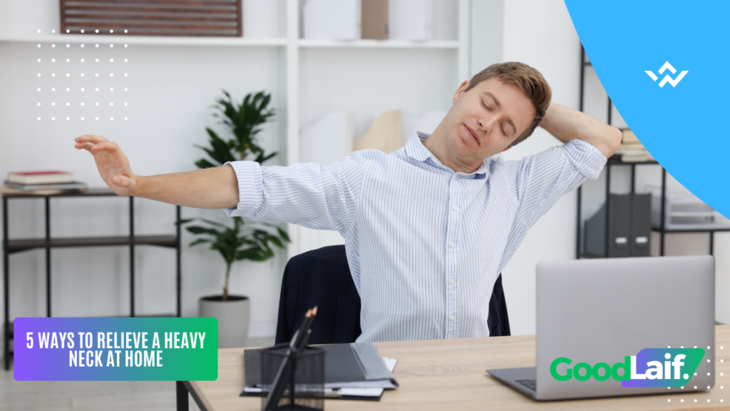 Man stretching his neck and shoulders at a desk to relieve neck feels heavy symptoms at home