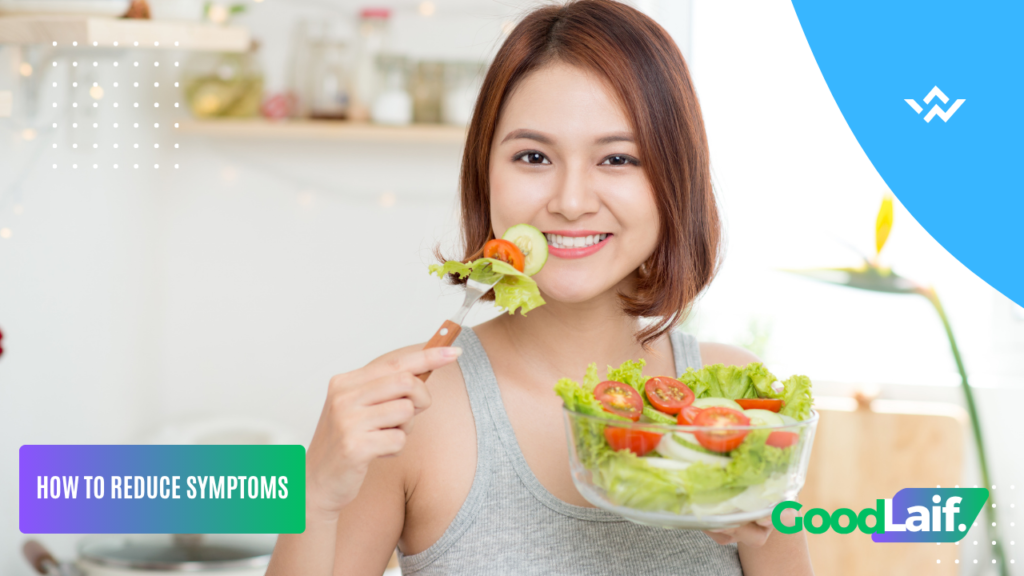 Smiling woman eating vegetable salad to help reduce acid reflux symptoms