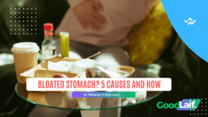 A person holding their stomach due to bloated stomach after eating too much fast food
