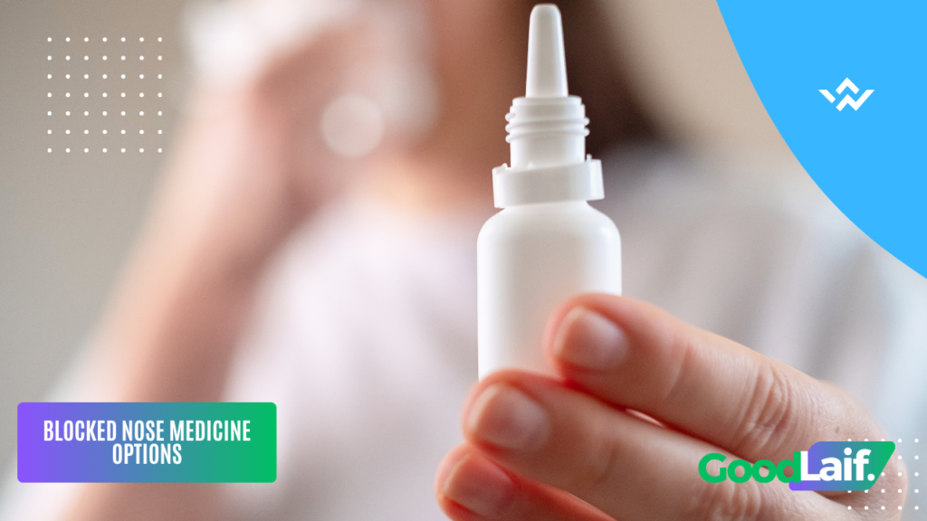 Hand holding a nasal spray bottle of blocked nose medicine to relieve breathing