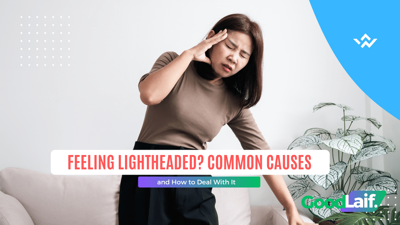 Woman holding her head due to feeling lightheaded and unwel