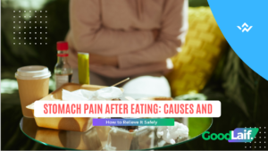 Photo of someone experiencing stomach pain after eating at a dining table