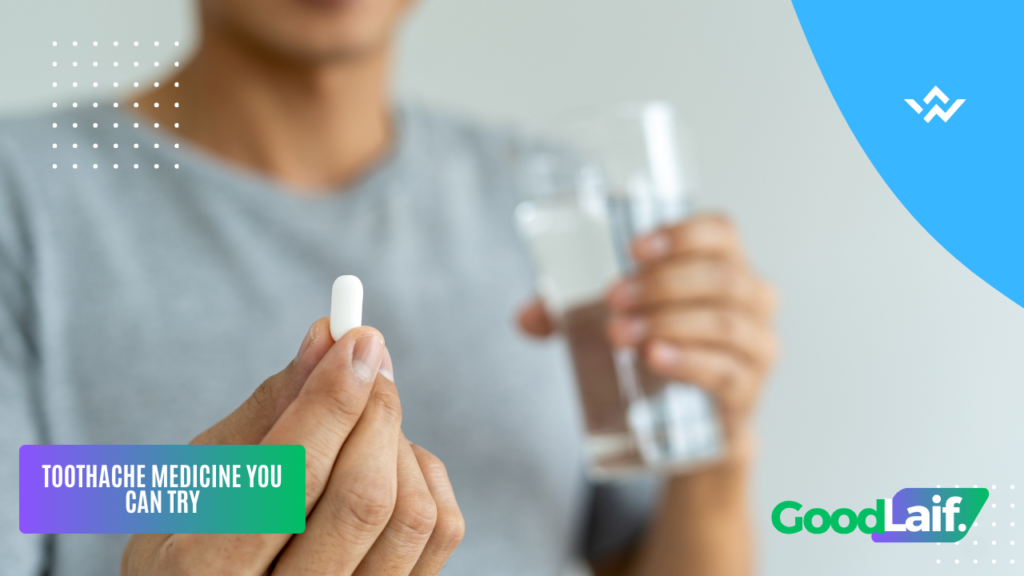 Person holding toothache medicine tablet and a glass of water