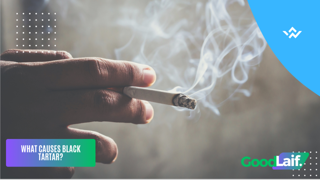 Hand holding a cigarette as one of the causes of black tartar