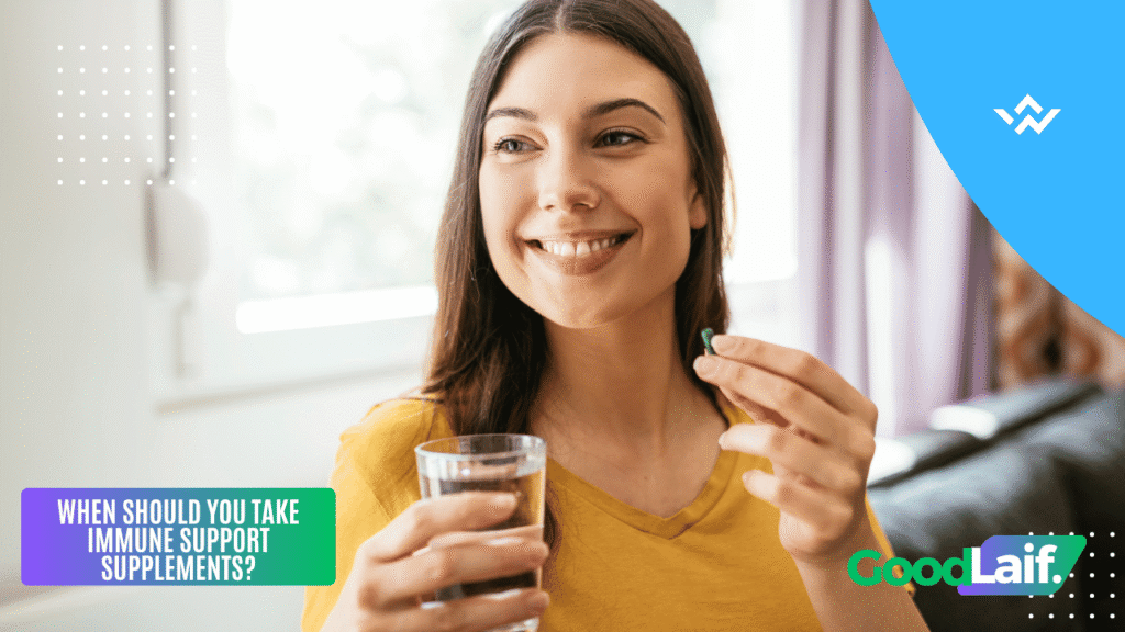 Smiling woman holding immune system supplements and a glass of water