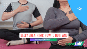 Two people sitting cross-legged with hands on chest and stomach while practicing belly breathing
