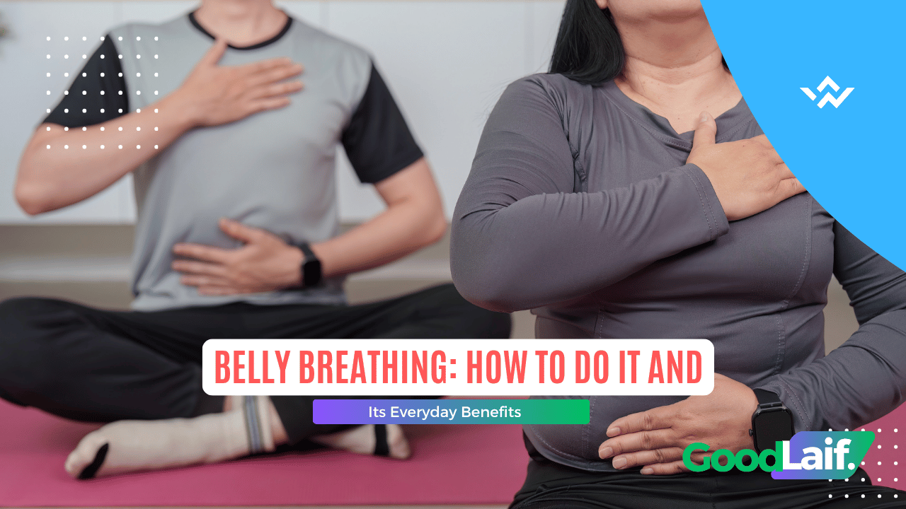 Two people sitting cross-legged with hands on chest and stomach while practicing belly breathing