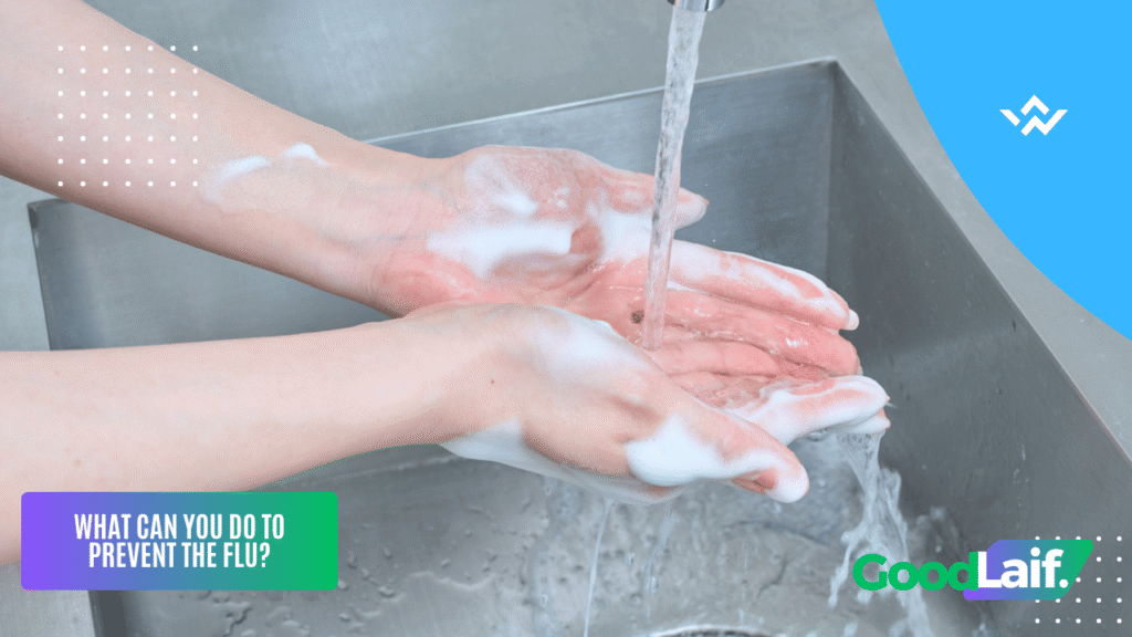 Illustration of washing hands with soap and running water as a way of how to prevent the flu