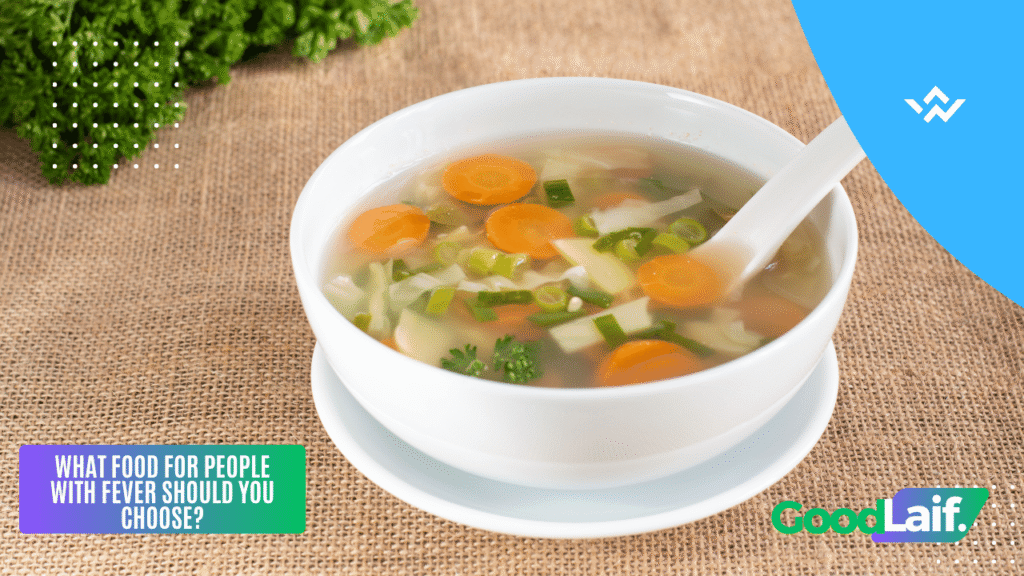 A warm bowl of chicken soup with carrots and vegetables as food for people with fever that is soft and hydrating