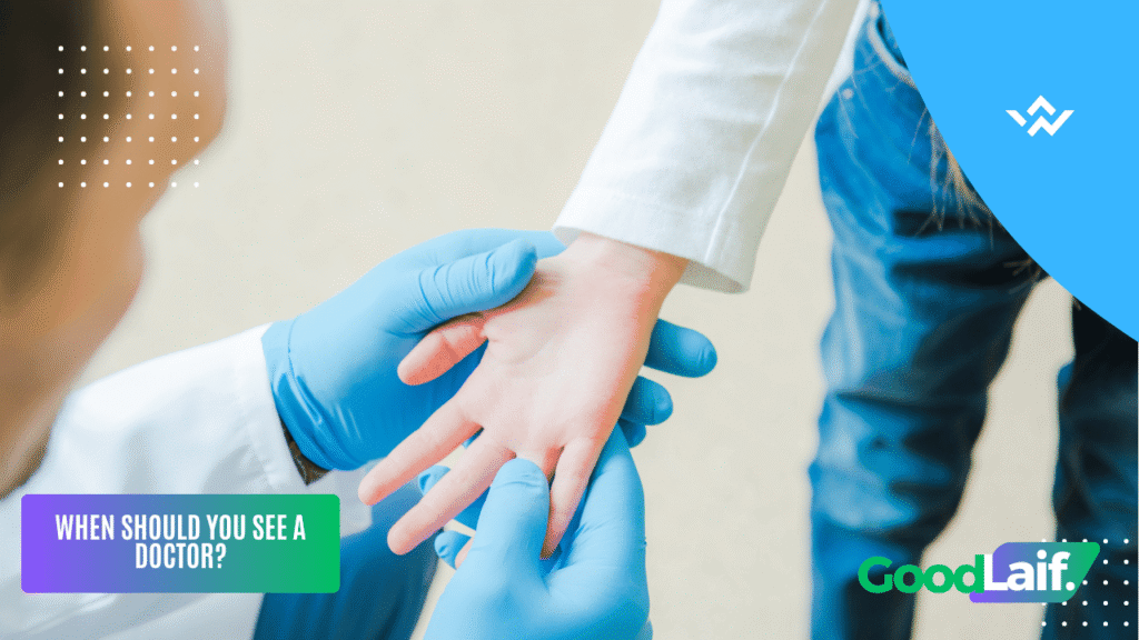 Doctor examining a hand for finger pain to know when to see a doctor