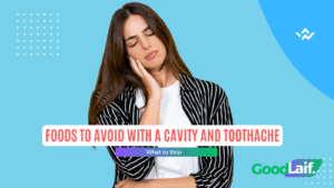 Woman holding her cheek in pain from a cavity, illustration of foods to avoid with a cavity and toothache